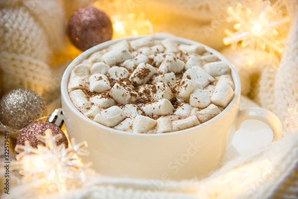 Fototapeta Christmas or New Year background with white cup of hot cocoa with marshmallows.
