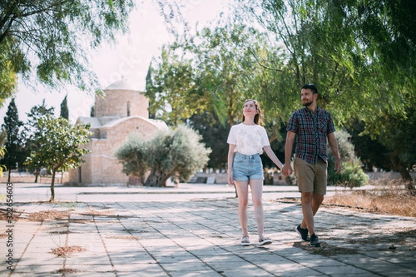 Fototapeta Lovers walk near the ancient temple