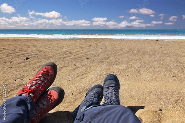 Fototapeta Relaxing on the beach after a long hiking tour
