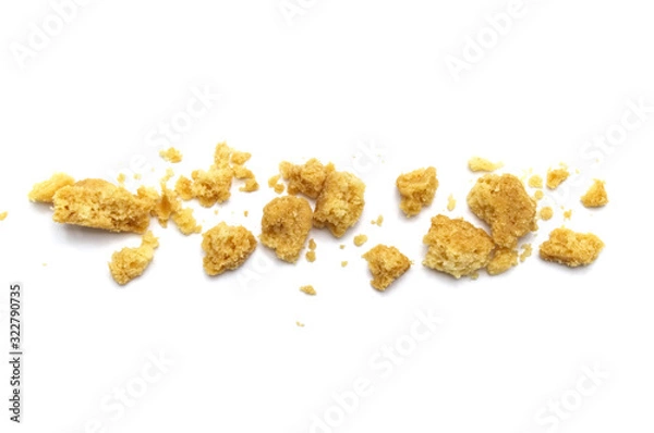 Obraz Scattered crumbs of butter cookies on white background.