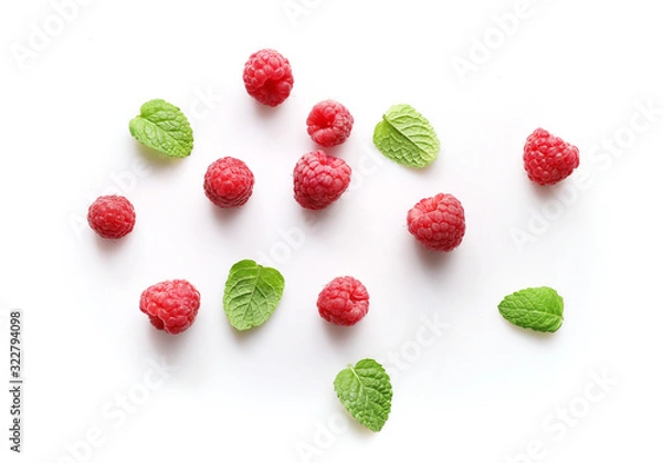 Fototapeta Ripe rasberries and mint isolated on white background. Top view