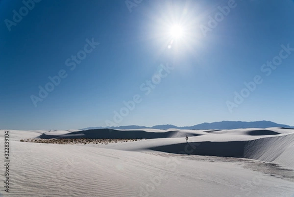 Fototapeta A man walking in the distance at White Sands National Park in Alamogordo, New Mexico. 