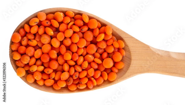 Fototapeta Red lentils in the wooden spoon isolated on a white background. Top view.
