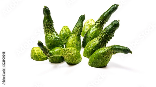 Fototapeta A set of green cucumbers laid out in an abstract image on a flat white surface