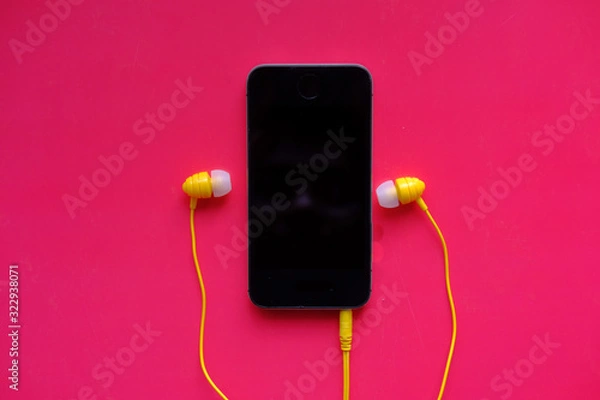 Obraz top view of smart phone and head phone on color background 