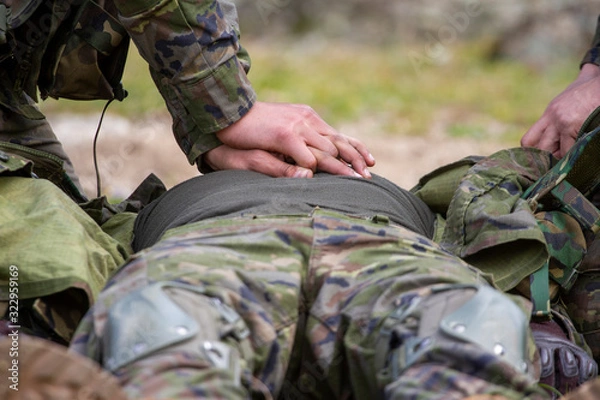 Fototapeta Resuscitation of a soldier in the field