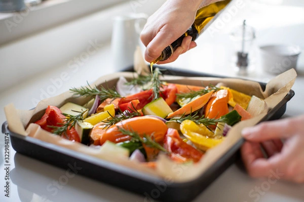 Obraz Close Up Of Seasoning Tray Of Vegetables For Roasting With Olive Oil Ready For Vegan Meal