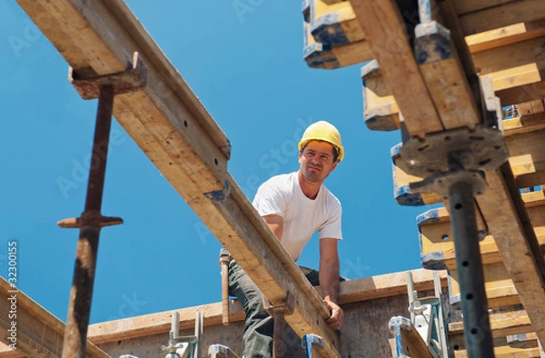 Obraz Construction worker placing formwork beams