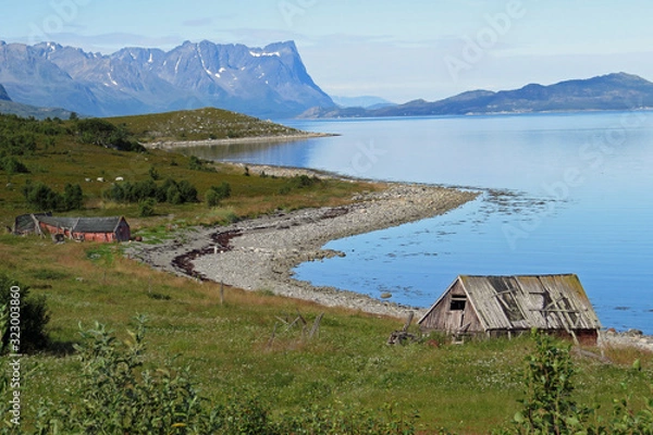 Fototapeta Panorama view of the bay coastline of the beautiful Porsangerfjord at low tide and overcast sky