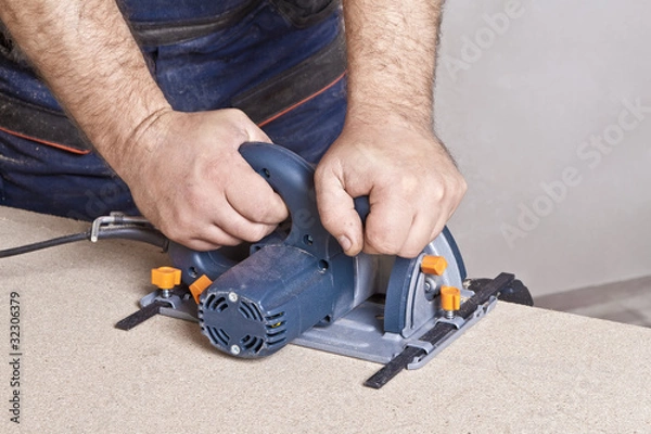Obraz Carpenter with circular saw