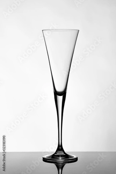 Obraz Tall, transparent, empty champagne glass on a white background