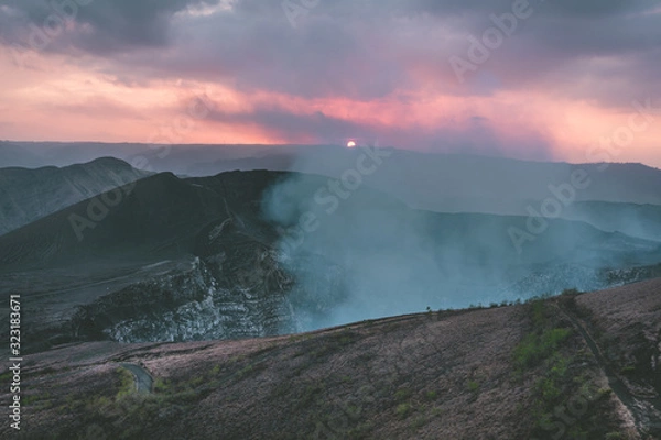 Fototapeta Sunset over volcano crater