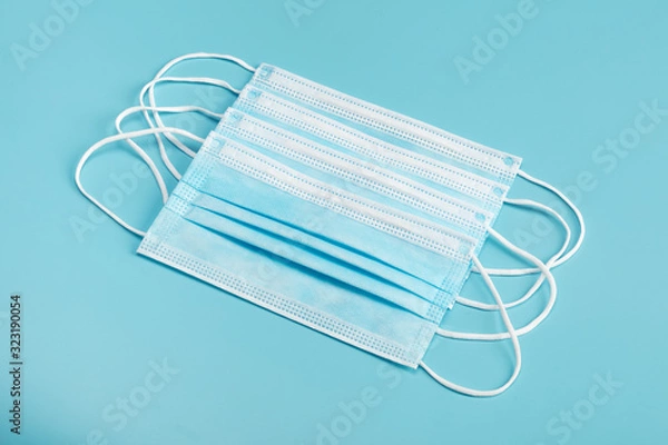 Fototapeta Medical mask on blue background.