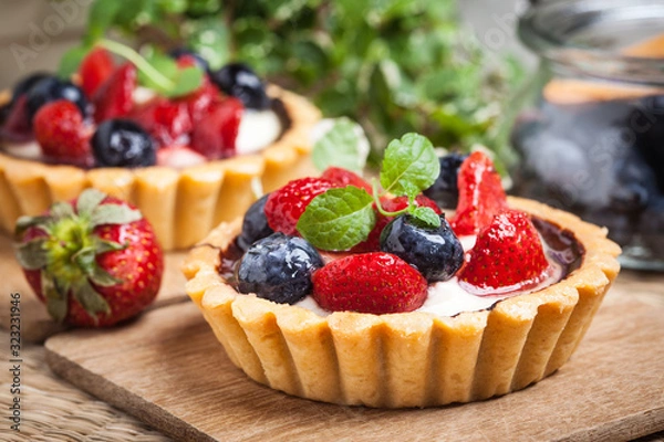 Fototapeta Fresh homemade fruit tart with strawberries and blueberries.