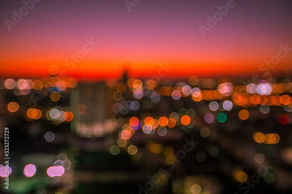 Fototapeta The blurry background of the bokeh, the colorful lights of the capital's residences, the beauty of the night shows the distribution of various types of residences (condominiums, offices, houses).