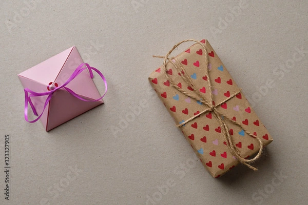 Fototapeta Valentine's day gift boxes on a cardboard beige background with space for your creativity and space for text.