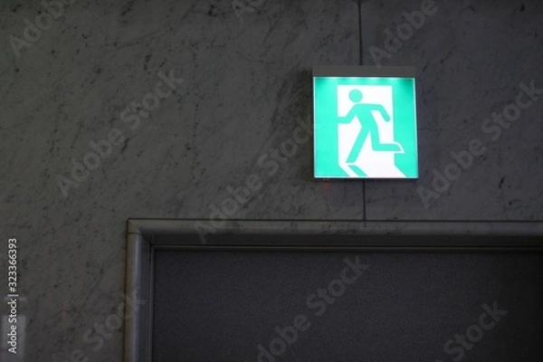 Obraz green exit sign on the wall