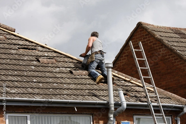 Obraz Workman repairing a roof
