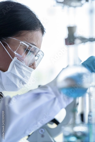 Fototapeta Asian young girl student scientist researching  and learning in a laboratory.