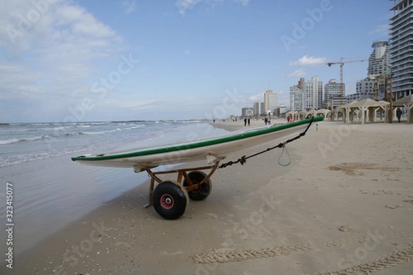 Fototapeta sup board on a transport trolley on a beach in the sand