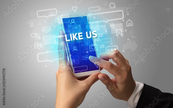 Fototapeta Female hand typing on smartphone with LIKE US inscription, social media concept