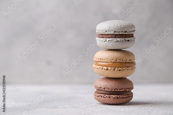 Fototapeta Macarons chocolate, caramel and vanilla on light background