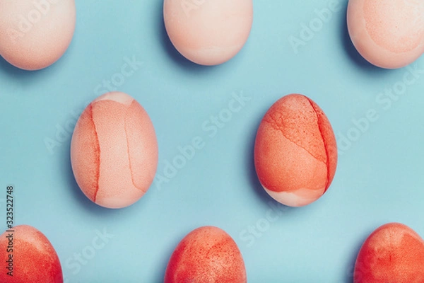 Fototapeta Pattern of red eggs on a blue background. Geometric Easter Concept