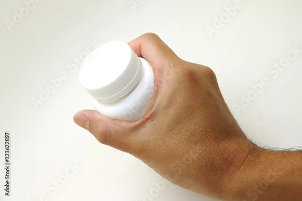 Obraz ボトルサプリメントを握る男性の手　プロテイン