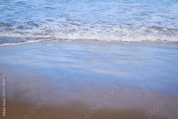 Obraz Light reflecting on breaking waves creating pastel prisms