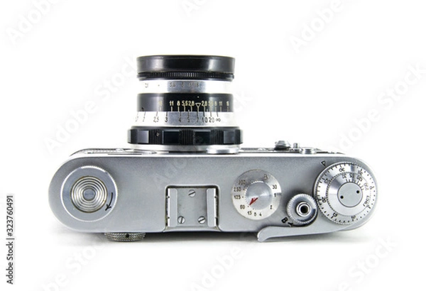 Fototapeta Old film retro camera "fed" with the lens. Metallic black. White isolated background. View from above