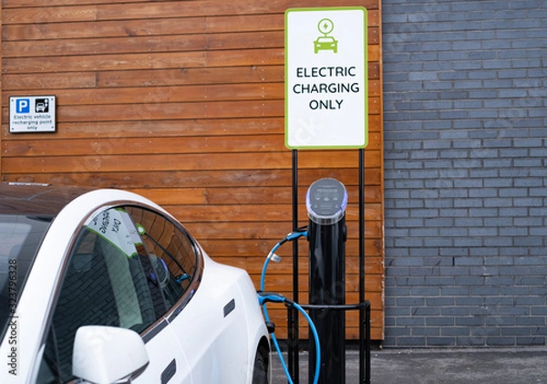 Obraz Electric car charging at public recharging point in UK