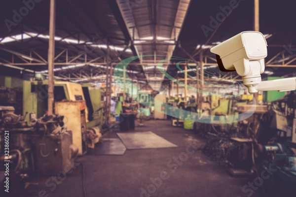 Obraz Technician installation CCTV  infrared camera technology 4.0 by screwdriver for look security area of work in construe worker show signage with factory work background.