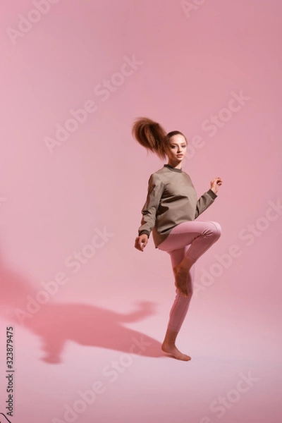 Fototapeta trendy studio fashion image of model, wearing color block clothes, casual spring style, color background, hipster girl posing