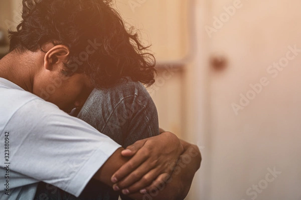 Fototapeta scared and alone, young Asian child who is at high risk of being bullied, trafficked and abused, selective focus
