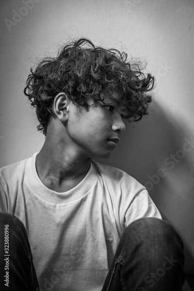 Fototapeta scared and alone, young Asian child who is at high risk of being bullied, trafficked and abused, selective focus