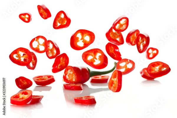 Fototapeta Chili pepper and its slices close-up falling