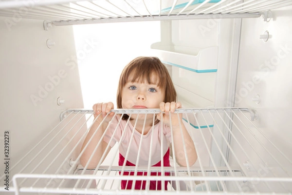 Obraz Girl looking in empty fridge