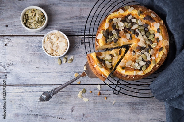 Fototapeta Pears and cheese pie with bowl of caramel and old spoon. Top view. Copy space flat lay
