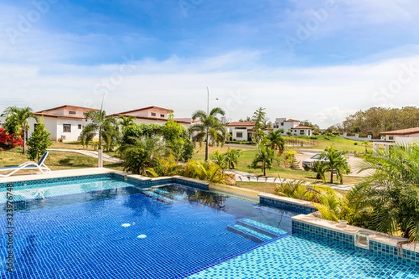 Obraz Swimming pool and the houses in the expat’s community project near Las Tablas in Panama.