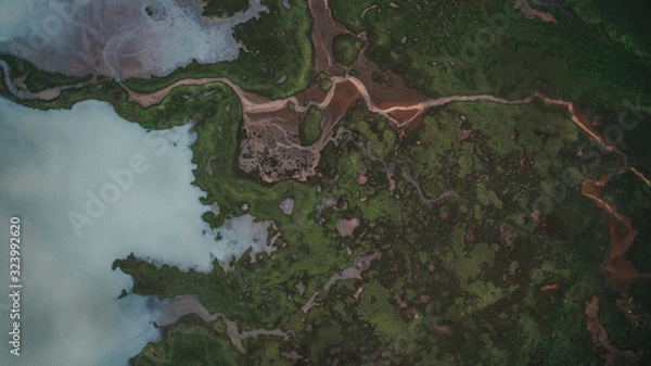 Fototapeta Aerial view river flows into a lake in Highlands of Iceland. Beautiful green patterns all over Iceland.