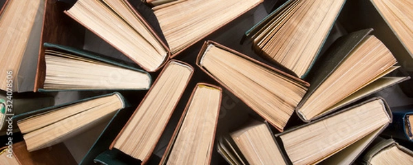 Fototapeta Old and used hardback books or text books from above.