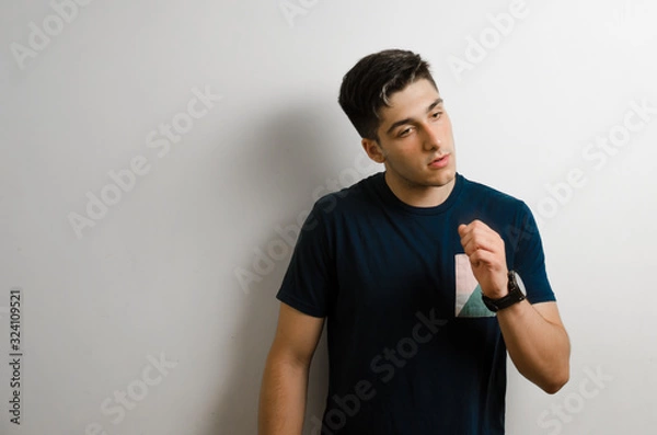 Obraz Young man looking to the side and thinking