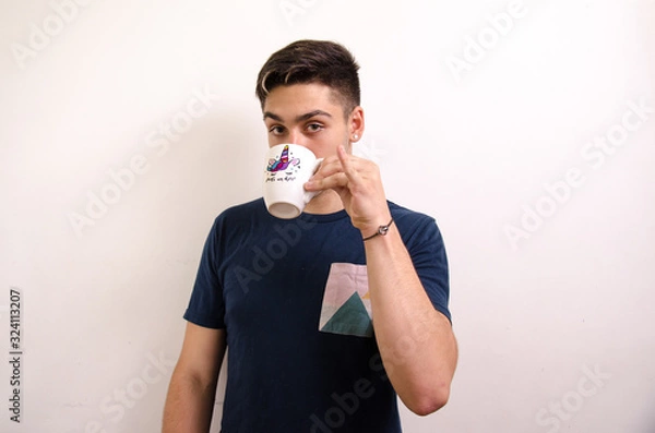Obraz Young man drinking from a jug
