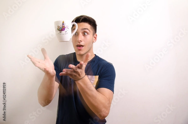 Obraz Young man with a jug in the air