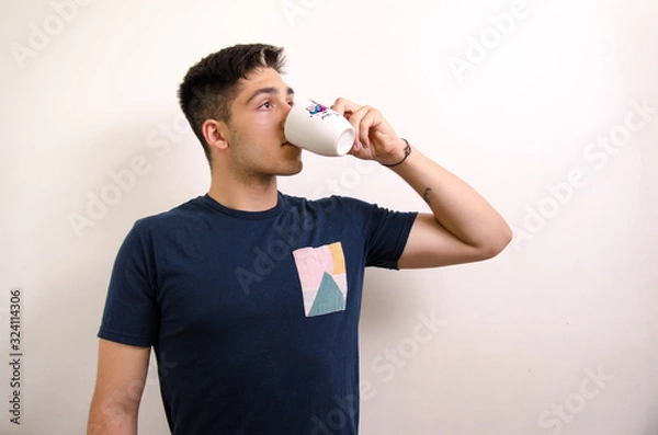 Obraz Young man drinking from a jug