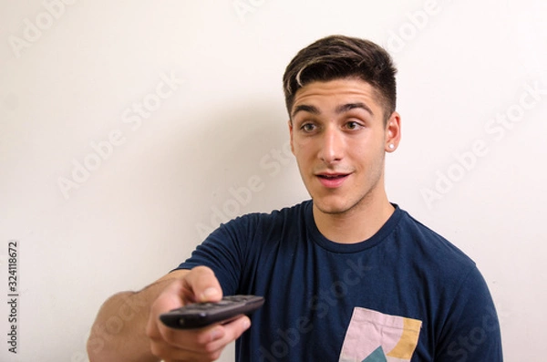 Obraz Young man with remote control