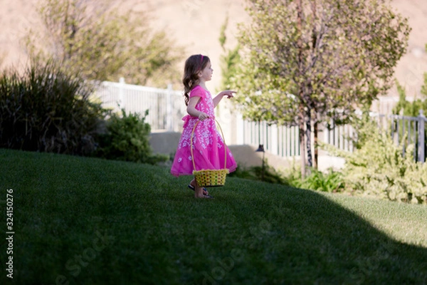 Fototapeta Sisters are having a competitive Easter egg hunt.