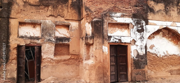 Fototapeta Islamabad,Pakistan,January 29,2020:Primitive arch design,ruined up walls,abandoned temple near to devastate,old building. The temple was built in 18th century situated in south Pakistan.