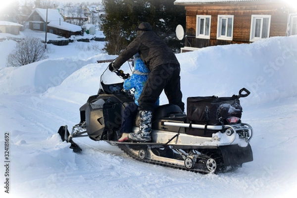 Obraz Snowmobiling from the mountain in winter