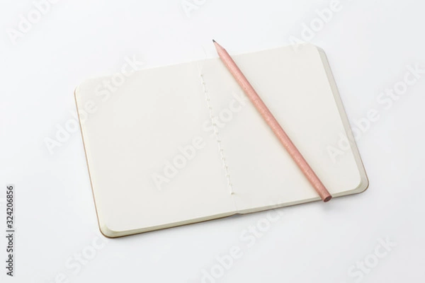 Fototapeta Top view of closed stitch blank recycled paper cover notebook with pencil on white background.